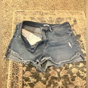 Good American high rise cut off blue jean shorts